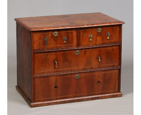 An early 18th century small walnut chest of two over two drawers. With cross hatched banding and brass drop handles, 63cm hig