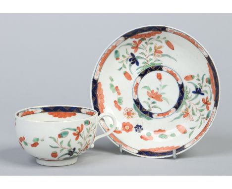 A Worcester teacup and saucer decorated in a Kempthorne type pattern with stylized flowers, c1770. Condition Report. To be us