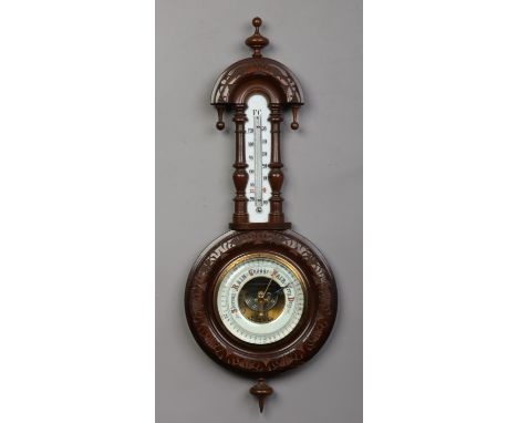 A carved walnut wall barometer incorporating a thermometer scale, 56cm. 