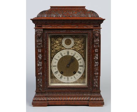 An early 20th century German carved walnut bracket clock. Housing a Lenzkirch eight day movement striking on two gongs, with 