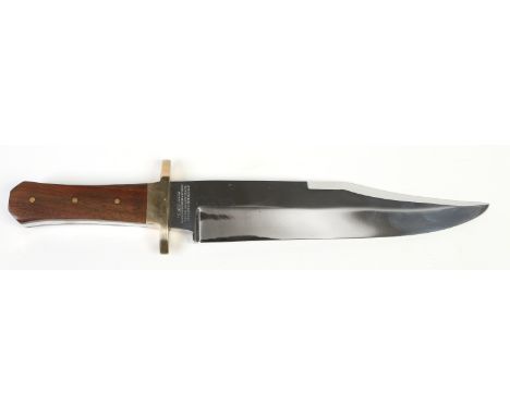 A Bowie knife in leather sheath by G. Wostenholm & Son of Sheffield. The blade with sharpened clip, and etched Geo. Wostenhol