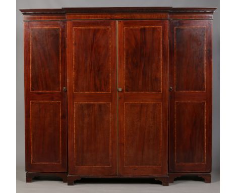 An early 19th century mahogany breakfront triple wardrobe with fitted interior. With satinwood banding and strung inlay, havi
