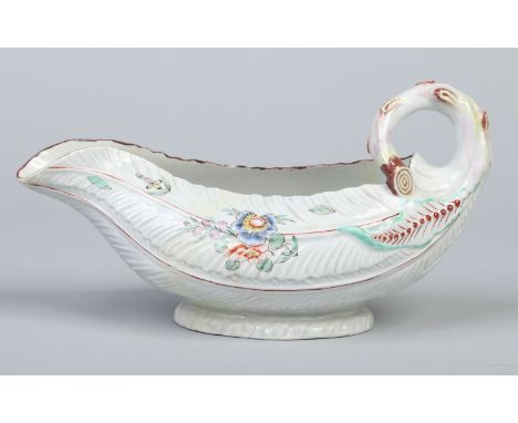 A Worcester cos lettuce leaf moulded sauceboat with looped stalk handle. Painted in polychrome enamels with flowers c1760, 22