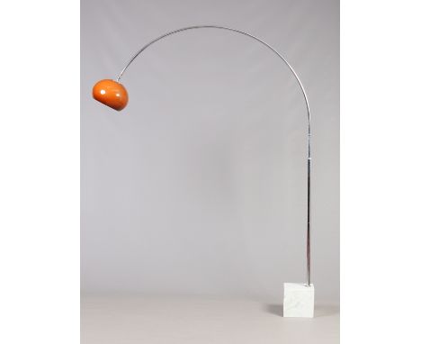 A 1970s floor lamp by Harvey Guzzini of chrome arch form with plastic amber shade and raised on a carrara marble plinth, 114c