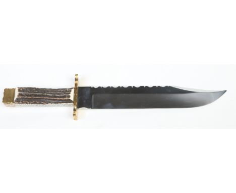 A Bowie knife in leather sheath by Reg Cooper of Sheffield. The blade with filework pattern. With scalloped brass cross guard