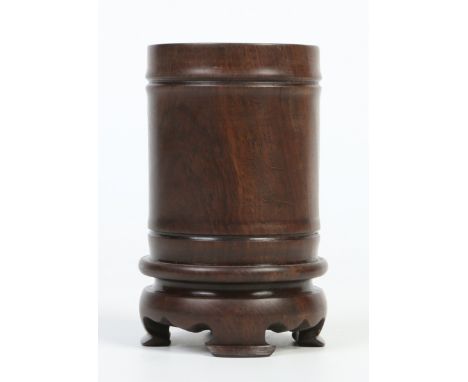 A Chinese carved hardwood brush pot of faux bamboo form and raised on bracket feet, 14.5cm. Condition Report. To be used as a