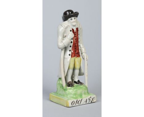A 19th century titled pearlware figure, Old Age. Formed as an old man supported by a crutch and walking stick. Decorated in o