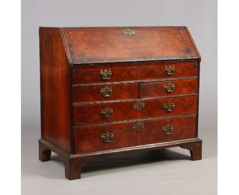 An early 18th century burr walnut bureau. With fitted interior, herring banded and raised on bracket feet, 105cm high, 110cm 