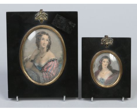 Two nineteenth century oval hand tinted and stipple engraved portrait miniatures of women in ebonized frames, largest 9.75cm.