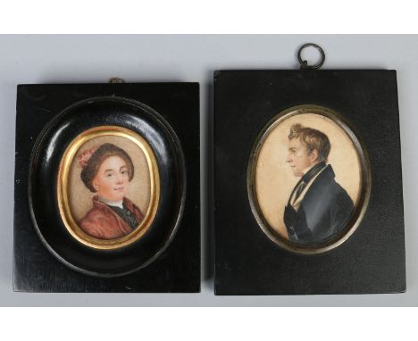 A Regency portrait miniature of a gentleman in profile view and a similar ivory portrait miniature of a man wearing a hat and