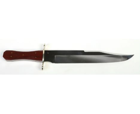 A Bowie knife. With a brass cross guard having rounded quillons  and hardwood scales. Blade stamped Sheffield, England. Blade