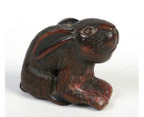 A Japanese early Meiji period carved fruitwood netsuke in the form of a rabbit, 4.25cm. Condition Report. To be used as a gui