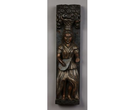 A hanging oak figural carving of a medieval lady with a basket of fruit supported on her head and playing a lute, 74cm high. 