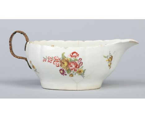 A large Bow sauceboat with lobed moulding and decorated with Duetsche Blumen c1760, 22cm handle to spout. Condition Report. T