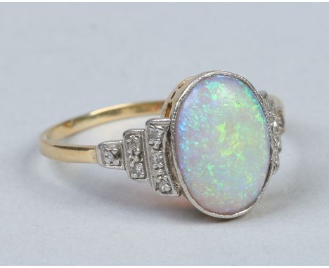 A gold and platinum Art Deco ring. Set with an ovoid opal on stepped shoulders set with diamonds. Ring size S. Condition Repo