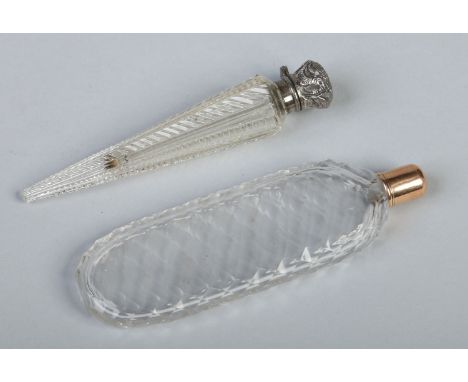 A nineteenth century faceted glass scent bottle with threaded yellow metal cover along with another cut glass scent bottle of