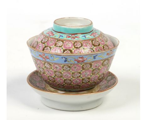 A 20th century Chinese eating bowl, cover and stand. Enamelled with pink and olive ground cells under turquoise and blue flor