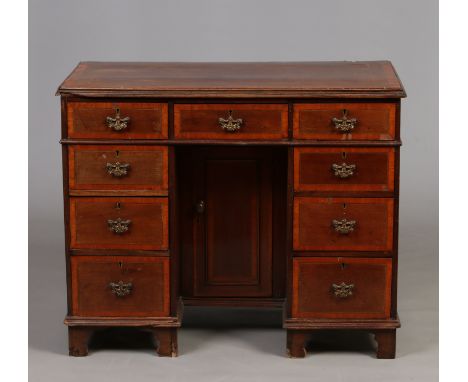 A Victorian mahogany knee hole writing desk. Crossbanded in satinwood and raised on bracket feet, 95cm wide, 48cm deep, 78cm 