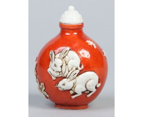 A Chinese Daoguang style scent bottle. Ground in rouge de fer and moulded with rabbits and vegetables. Four character seal ma