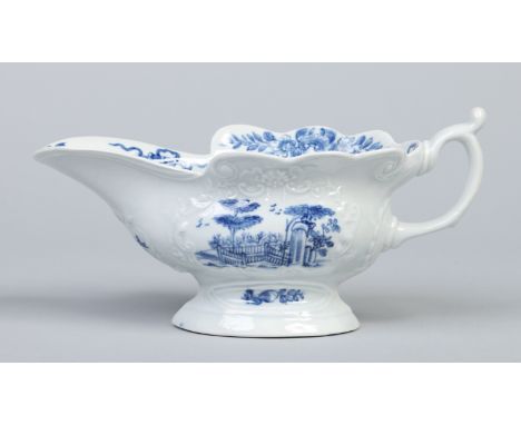 A Worcester silver shaped sauceboat. With moulded cartouches and painted in underglaze blue with the plantation pattern and t