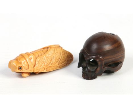 A Japanese carved wood netsuke formed as a skull and another ivory example carved as a cricket. Both signed.  Condition Repor