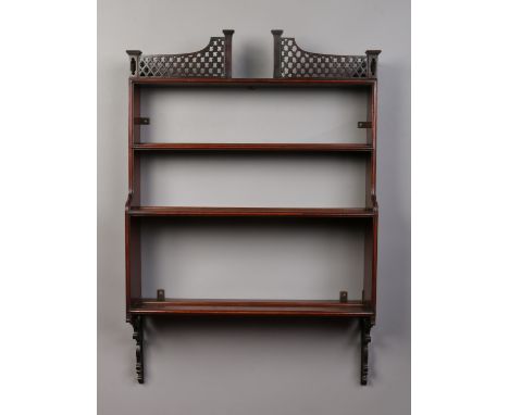 A Victorian mahogany four tier hanging wall shelf with open fret work pediment, 92cm. Condition Report. To be used as a guide