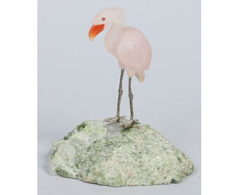 A carved rose quartz model of a flamingo with cornelian beak and raised on a green mineral plinth, 11.5cm.  Condition Report.