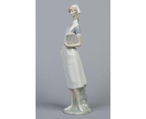A large Lladro figure in the form of a nurse. Printed mark, 41cm. Condition Report. To be used as a guide only. Good conditio