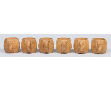 A set of six Robert "Mouseman" Thompson carved oak octagonal serviette rings. Each with the Mouseman device, 5cm. Condition R
