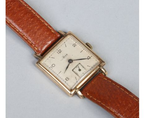 A gentleman's Art Deco Avia manual wristwatch in 9 carat gold Dennison case with scrolling lugs. With square silver dial havi