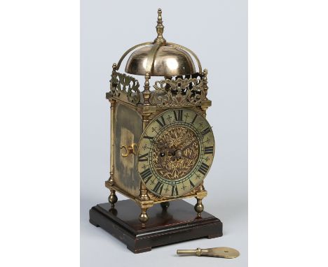 A brass single fusee lantern clock on moulded wooden plinth. With anchor escapement and having brass bob pendulum with stirru