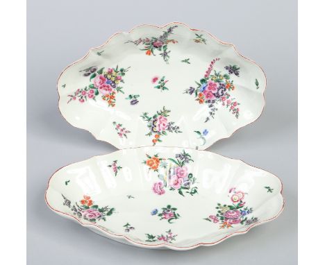 A pair of Worcester scalloped lozenge shaped dishes. Painted in coloured enamels with flowers, c1770, 25.75cm wide.  Conditio