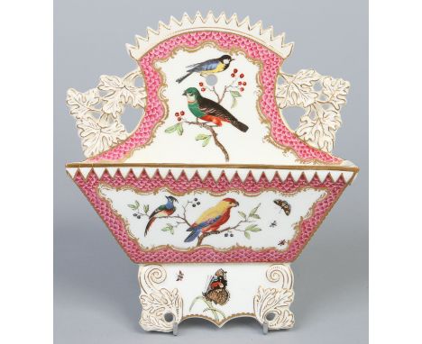 A 19th century Coalport pierced wall mounting letter rack, painted with birds on a scale pink ground probably by John Randall