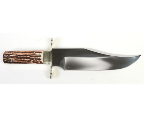 A Bowie knife. With brass cross guard having rounded quillons and antler scales. Blade stamped Sheffield, England. Blade 22cm
