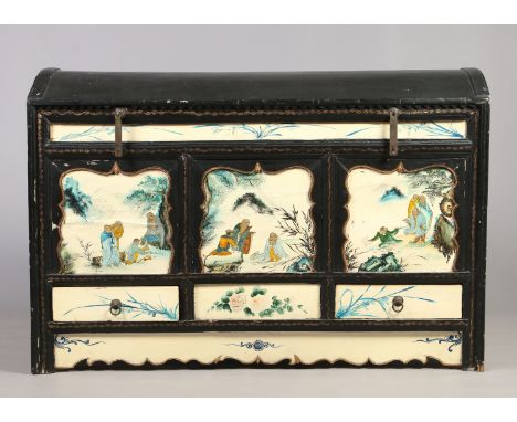 An early 20th century Oriental large painted dome top trunk. Ebonized and with painted ivory ground panels depicting figures 