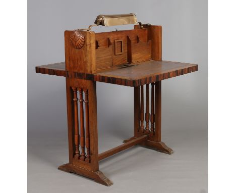 An Art Deco walnut and coromandel leather top lobby writing table. Fitted with stationary boxes, with an overhanging brass de