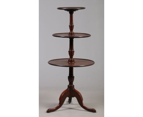 A George III mahogany three tier dumb waiter with dished tops each with carved moulding and raised on a plain carved tripod s