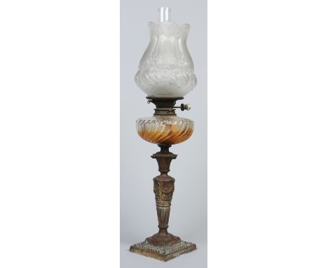 A Victorian oil lamp with frosted shade, moulded glass font and raised on a Classical style plinth, 73cm.  Condition Report. 