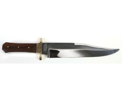 A Bowie knife in leather sheath by G. Wostenholm & Son of Sheffield. The blade with sharpened clip, etched I*XL and with mott