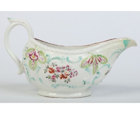 A Derby sauceboat moulded with a gardrooned rim, flowers and C scrolls. Edged in turquoise and enamelled with flowers in the 