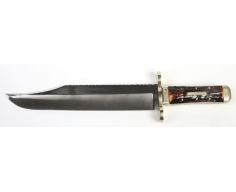 A Bowie knife by Stan Shaw of Sheffield. With antler scales rounded brass cross guard and engraved brass pommel. Having ornat
