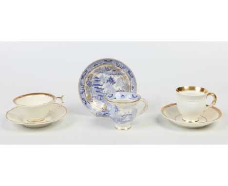 Three Rockingham cups and saucers. Two decorated with gilt bands and the other gilded over a transfer printed chinoiserie lan