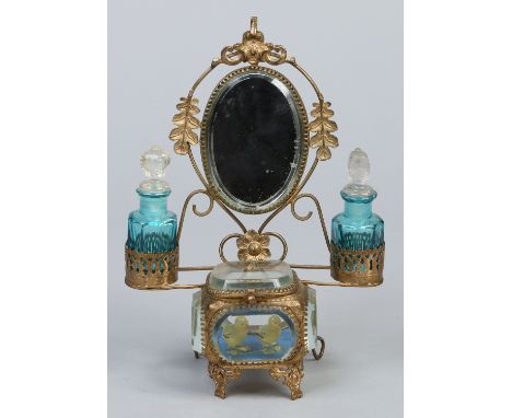 A Continental gilt brass and glass trinket box / pocket watch holder in the form of a dressing table. With an oval bevelled m