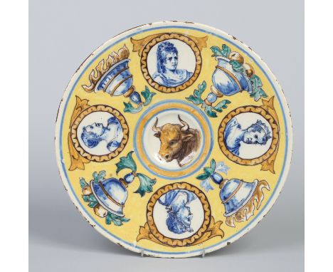 An antique Maiolica dish, yellow ground, painted with portrait roundels and with a bull to the centre, 31.25cm diameter.  Con