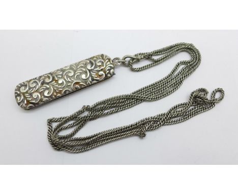 A white metal comb on a chain 