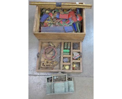 A wooden box containing two sections of vintage Meccano parts 