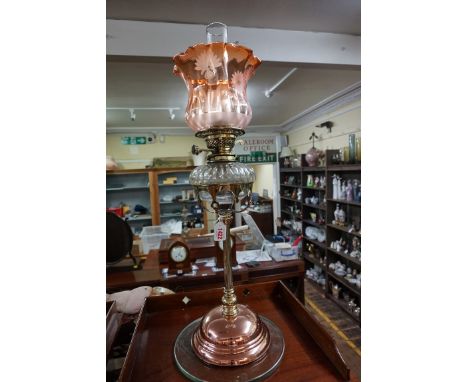 A good late Victorian brass and copper oil lamp,&nbsp;with etched cranberry glass shade, height excluding chimney 64.5cm.&nbs