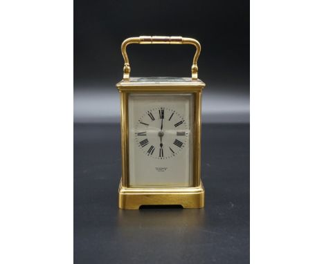 An antique brass carriage clock,&nbsp;striking on a gong, the enamel dial inscribed 'Carrington', height including handle 16.