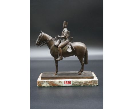 A bronze figure of a continental cavalry figure,&nbsp;on marble base, total height 22cm. 