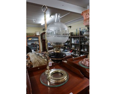 A good late Victorian brass adjustable oil lamp,&nbsp;with ruby glass reservoir, total height 63cm.&nbsp; 